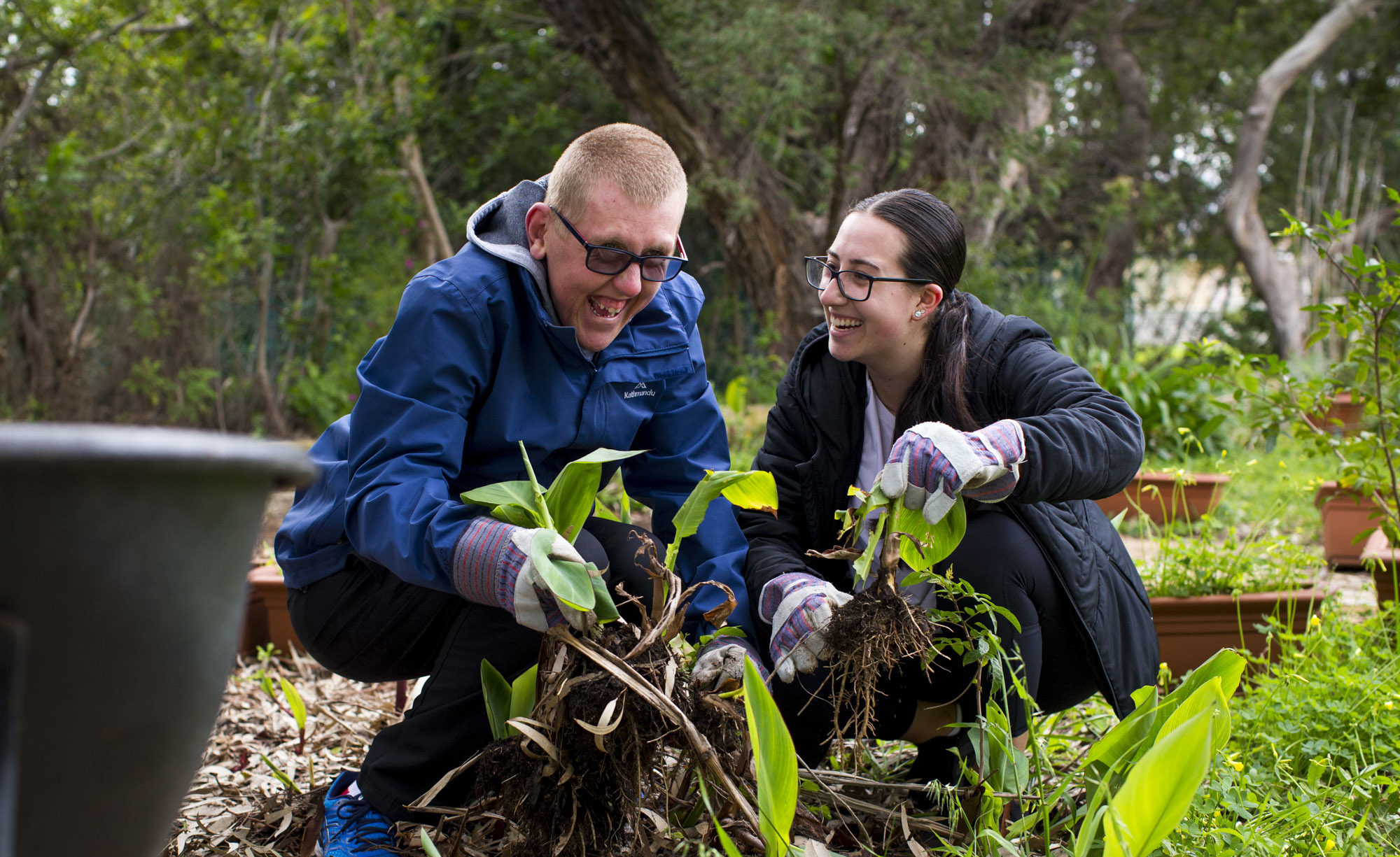 Custoemr Connow and Support Worker Steph garden together.