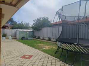 back garden with trampoline, shed and grassed area